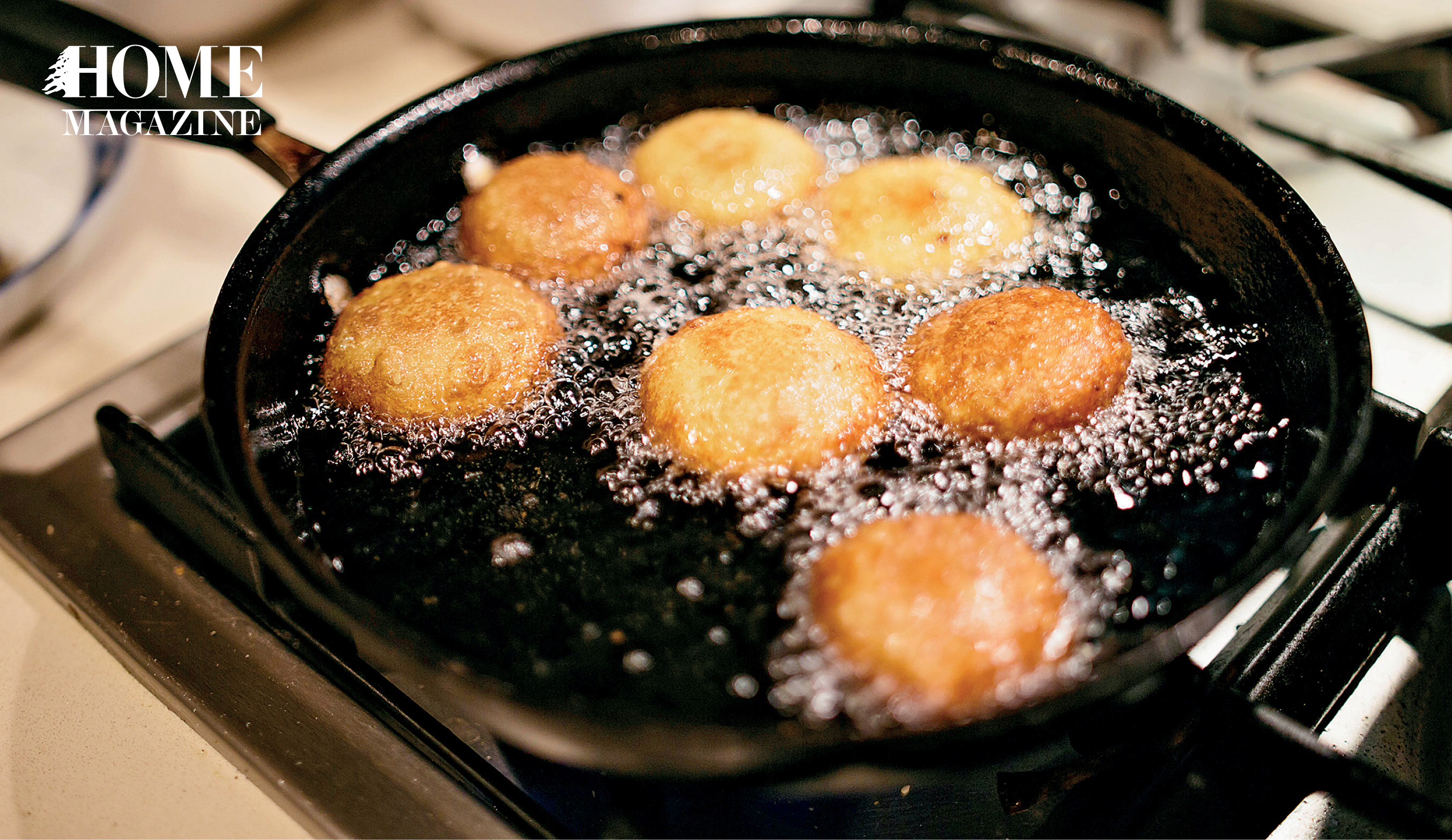 Brown rolls boiling in a back pan