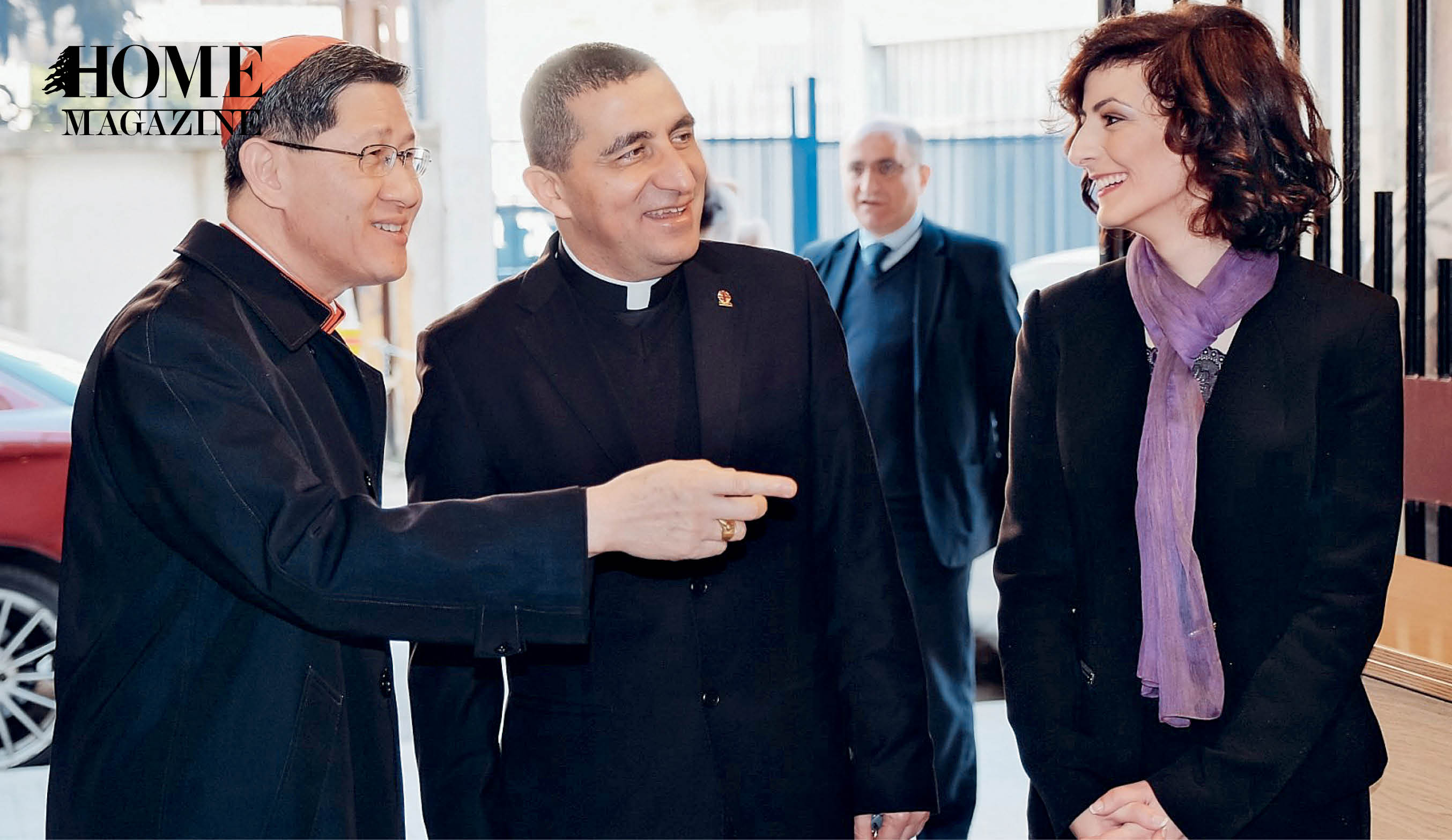 Cardinal with red hat, father with back robe and woman in black clothes and purple scarf