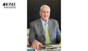 Man with white hear and grey suit