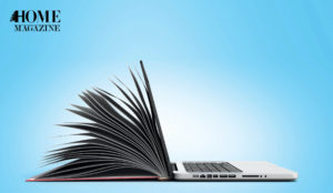 An open book stuck to the side of a laptop