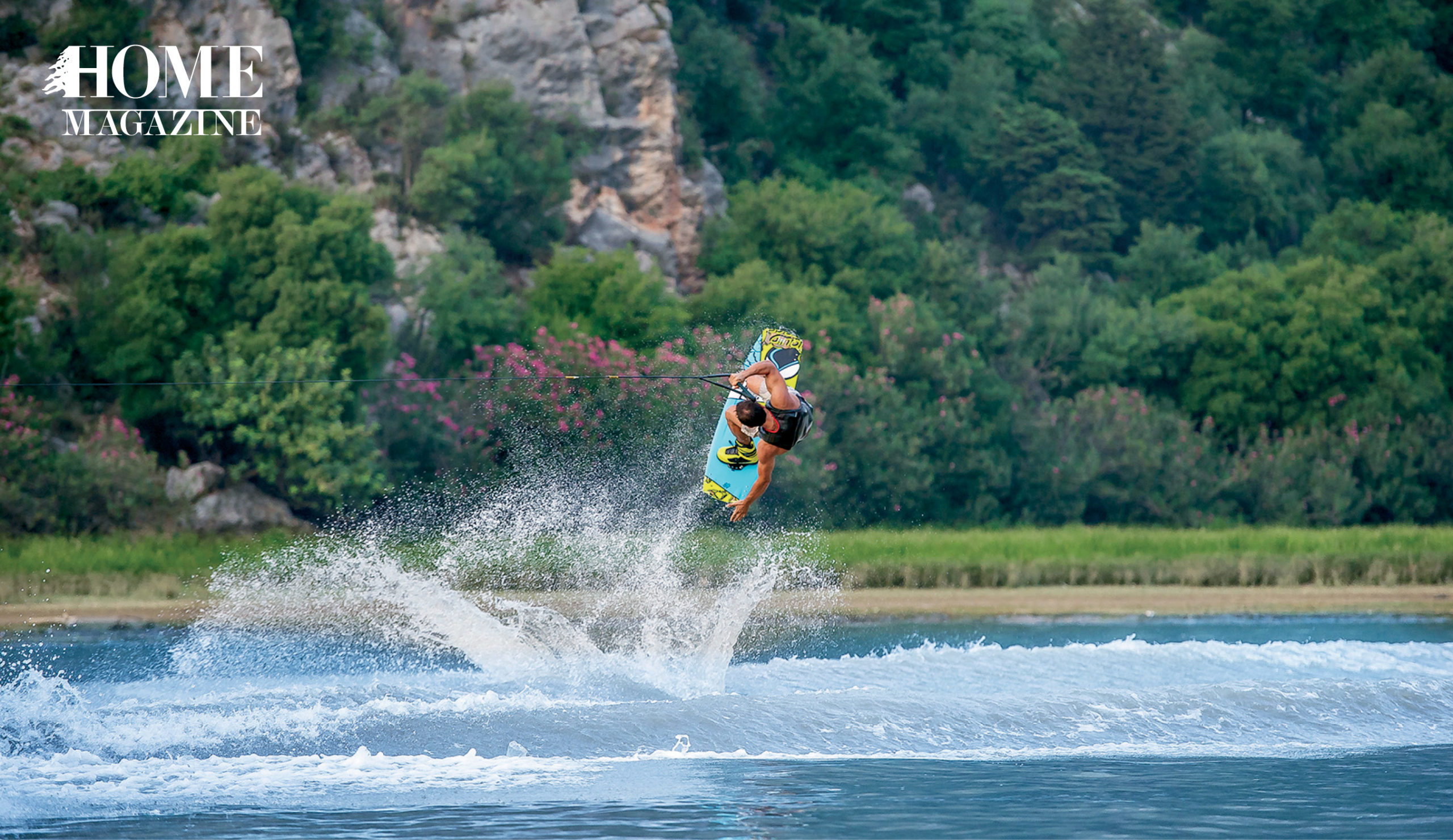 Man water surfing and flipping in the air