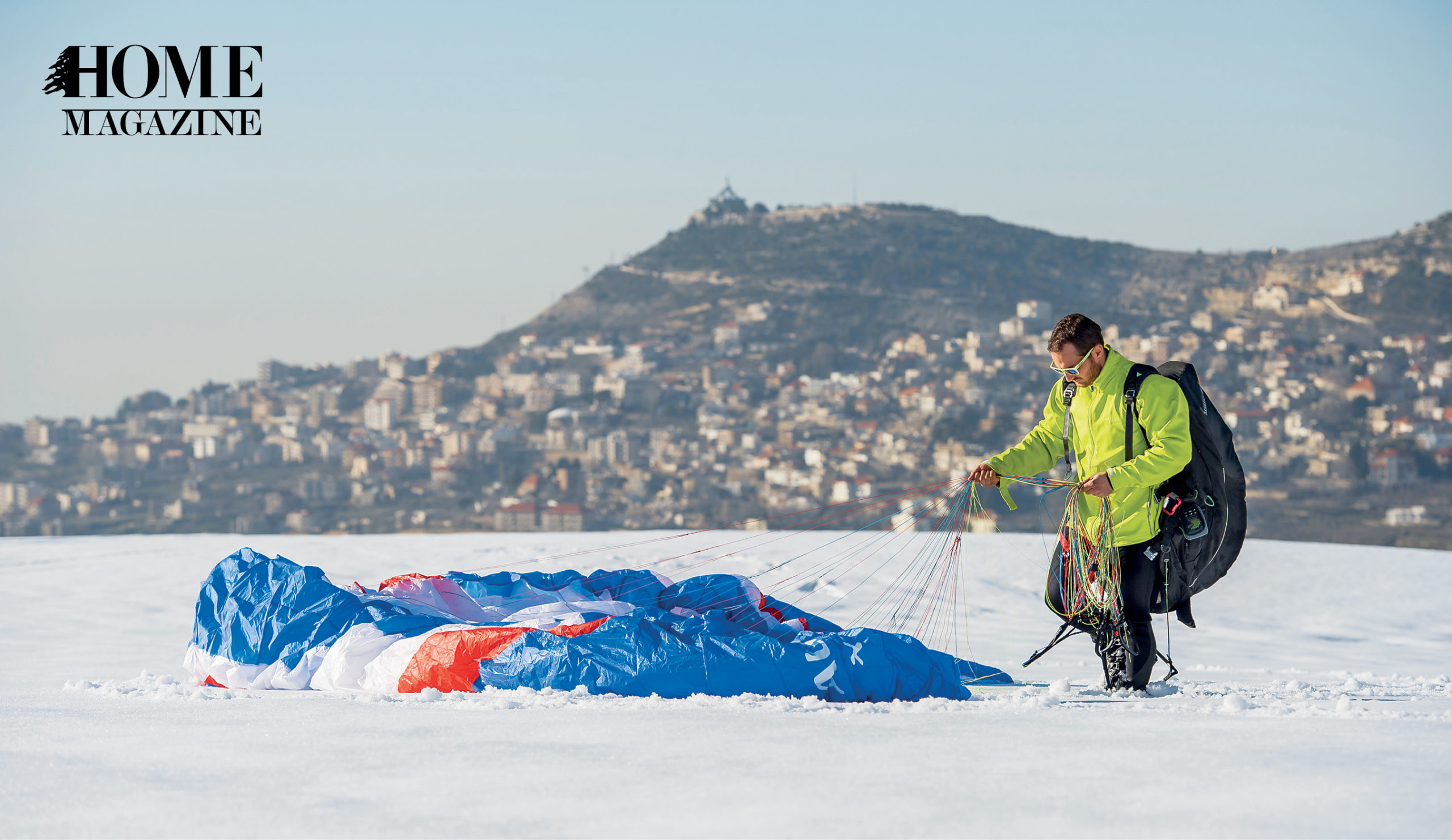 Man with glider on snow