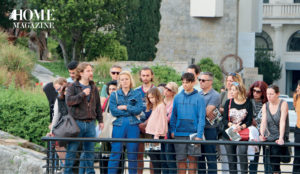 Group of people behind a metal barrier